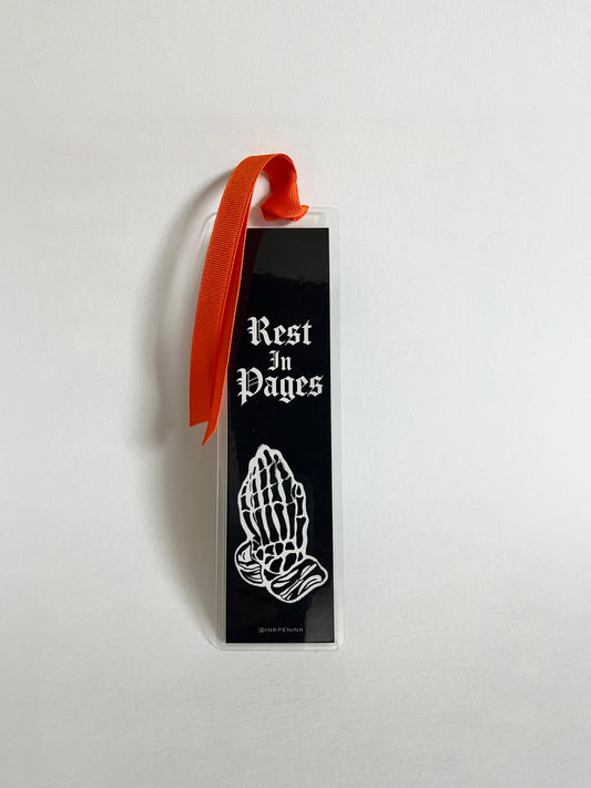 Bookmark with 'Rest In Pages' text and praying hands design on a white background