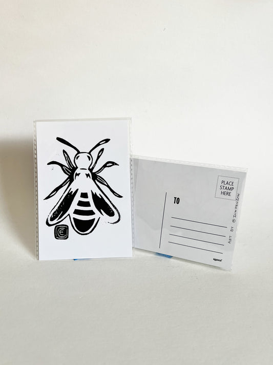 Postcard with bee illustration and a blank postcard on a light gray background