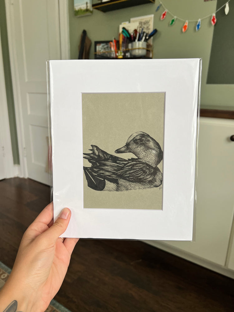 Hand holding an drawing of a duck