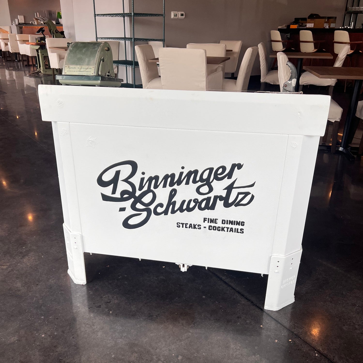 White hostess stand with black text