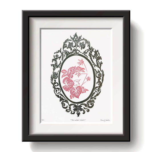 Framed artwork with a decorative baby Robbin design pink ink on a white background