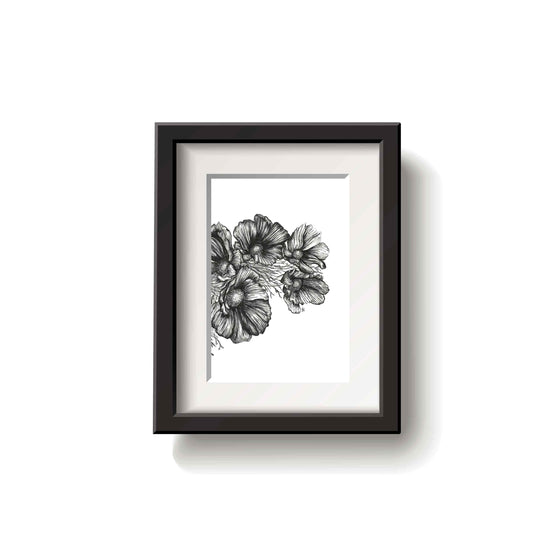 Framed black and white floral drawing on a white wall
