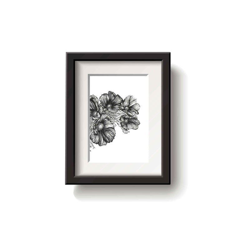 Framed black and white floral drawing on a white wall