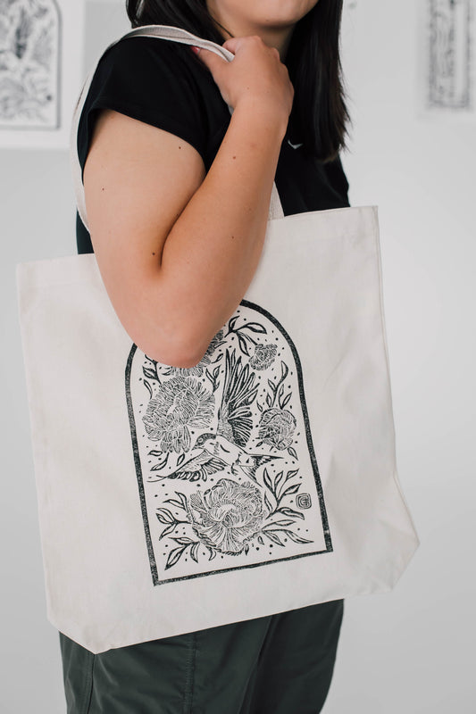 women holding a printed tote bag