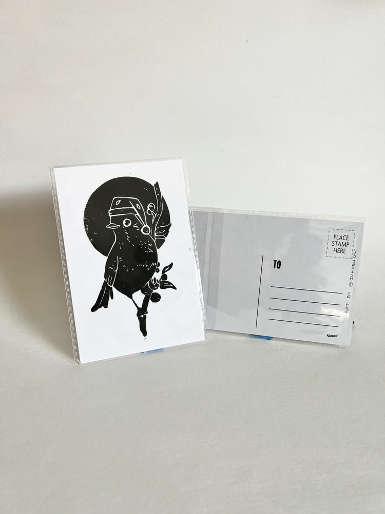 Greeting card with black and white illustration of a bird wearing a hat, next to an envelope on a light gray background.