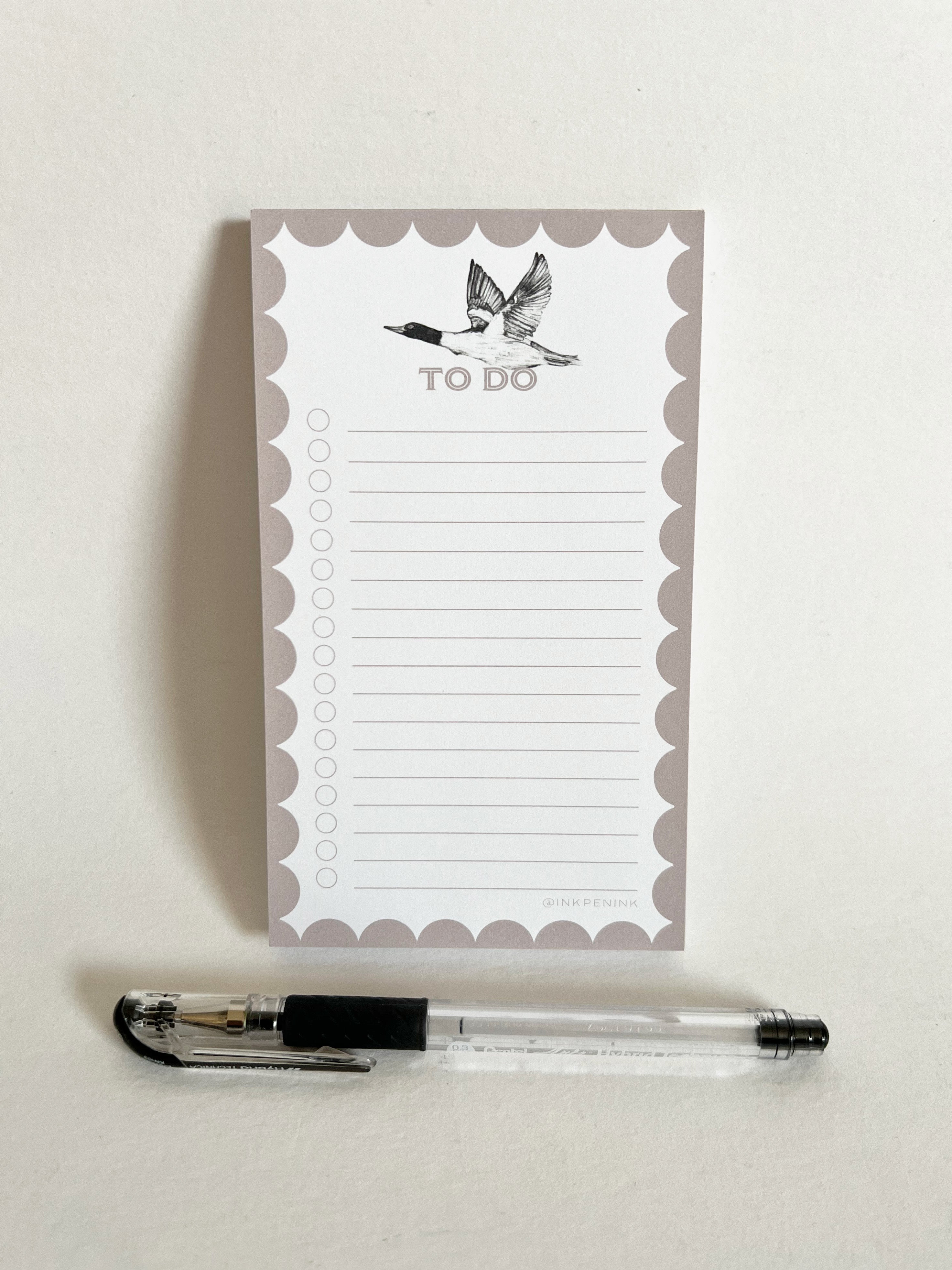 Notepad with 'To Do' list and a pen on a light background