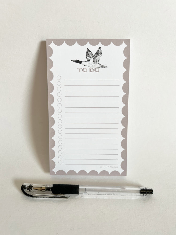 Notepad with 'To Do' list and a pen on a light background