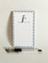 Notepad with 'Just a Note' text and penguin illustration, accompanied by a pen on a light background