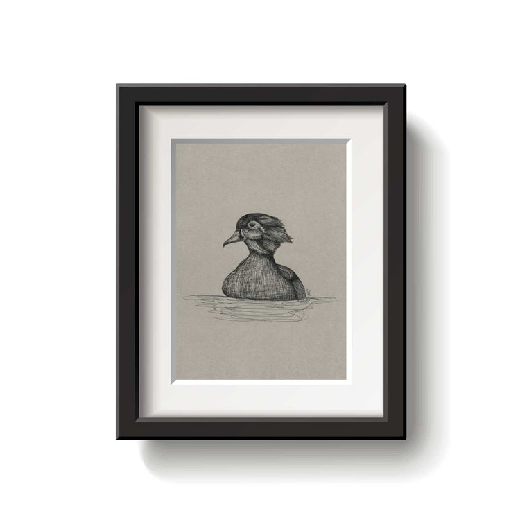 Framed artwork of a duck on a beige background